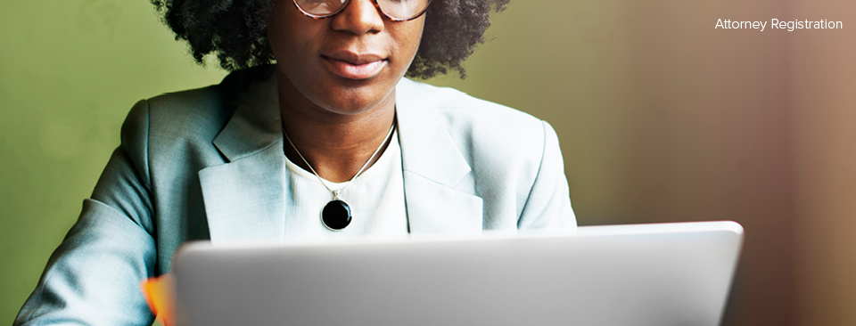 Attorney sitting at a desk completing attorney registration